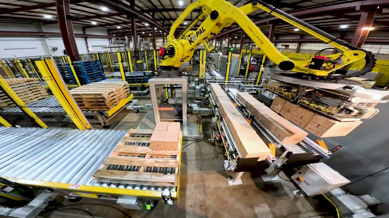 Kaufman KPal V Robotic Palletizer, EXPA-15 Stretch Wrapper, Conveyor and Transfer Car System.