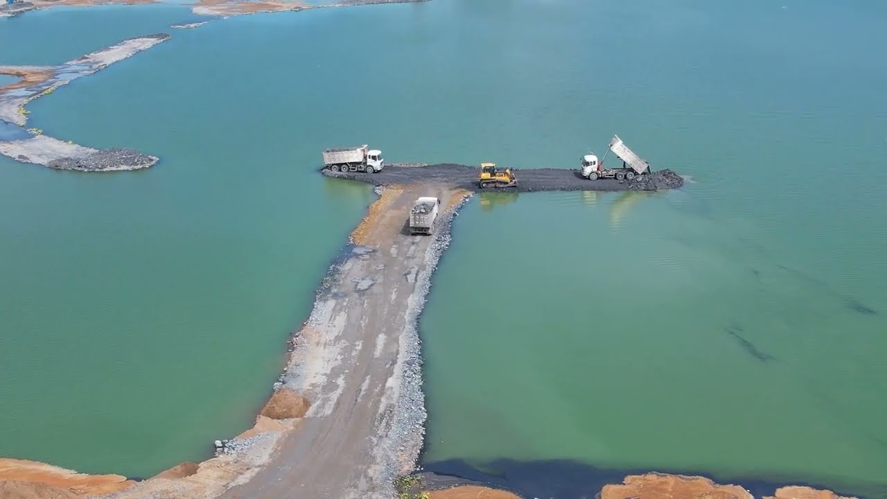 Amazing much earth and stones are poured to build a road over water dozer SHANTUI &Truck 25Ton
