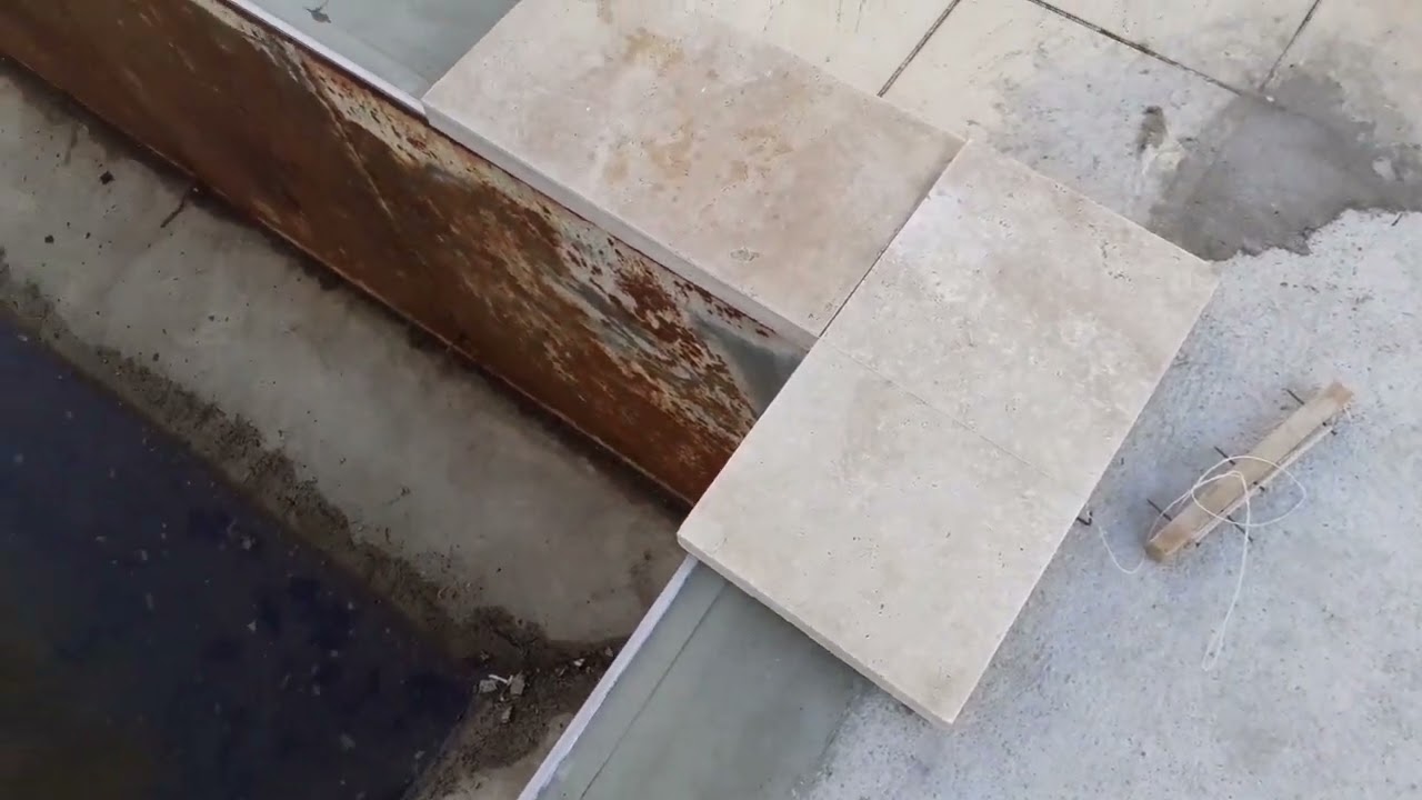 Como colocar pedras na borda da piscina.