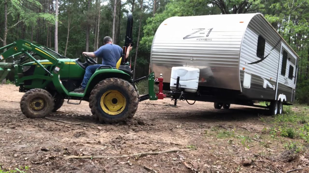 John Deere 3025e moving the travel trailer with the Titan Attachments 3 point tractor trailer hitch.