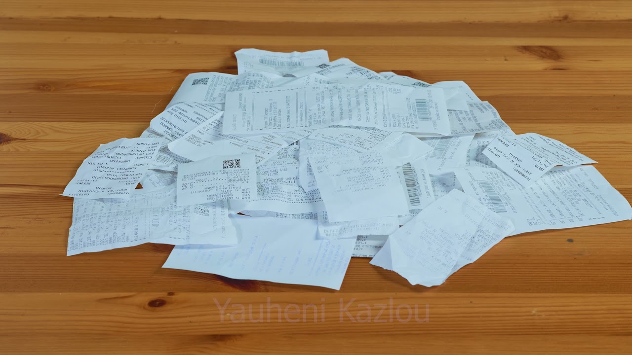 Paper receipt pile. Shopping receipts on a wooden table - Stock Video & Footage