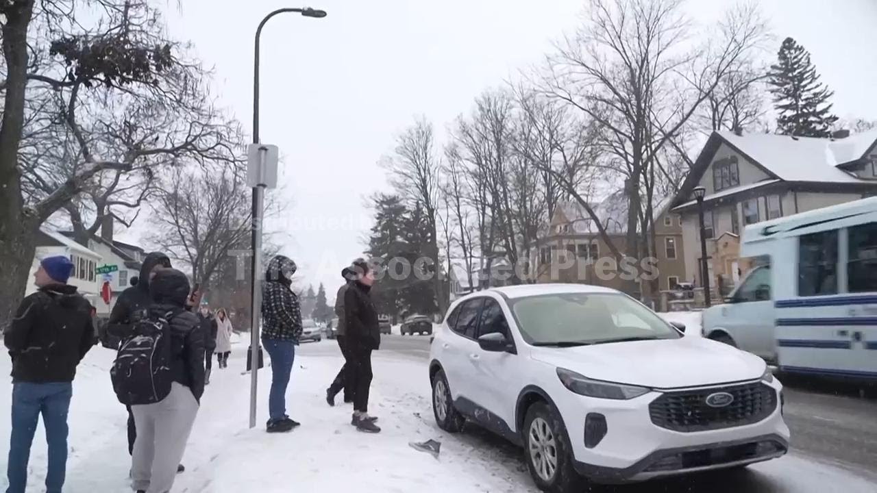 People blow whistles and stand near vehicles believed to be driven by ICE agents