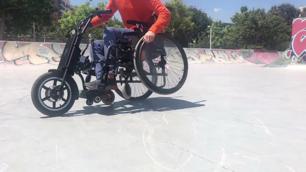 A wheelchair in a skatepark with a power add-on UNAwheel Maxi