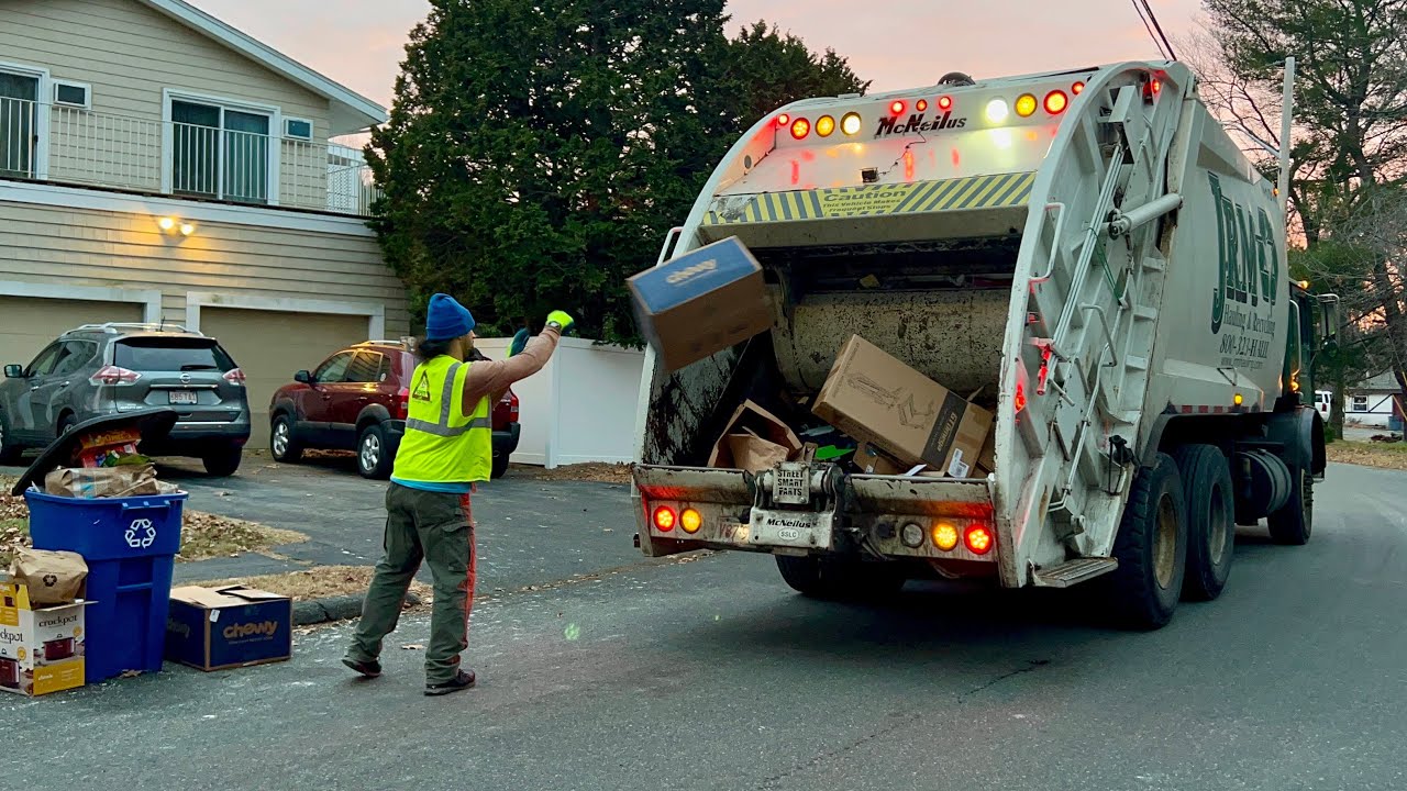 JRM Garbage Truck Packing Heavy Post Xmas Recying At Sunset
