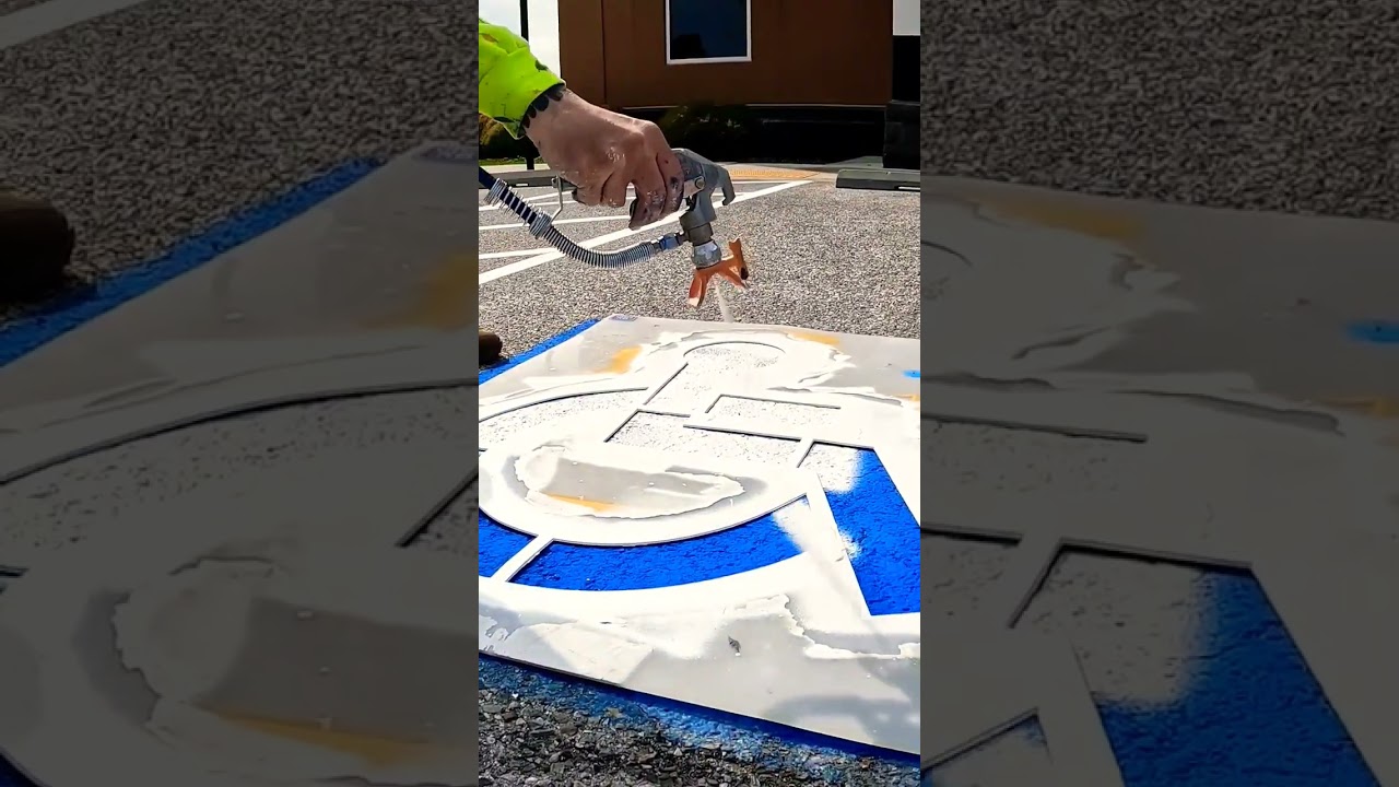 Painting a handicap parking stahl.
