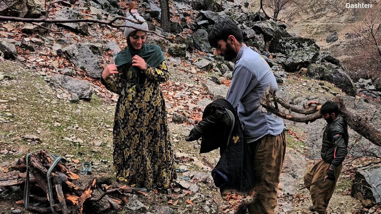 Leila and Shahin are helping each other to pack the rocks of the mountain hut, and it is raining hea