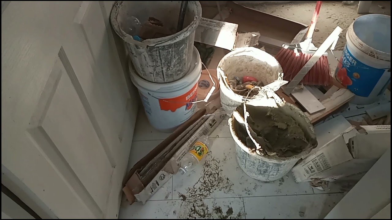 young man with great tiling skills, DIY , on the construction work jamaican style