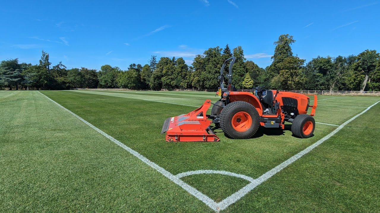 On Board KUBOTA TRACTOR cutting GRASS football pitch.