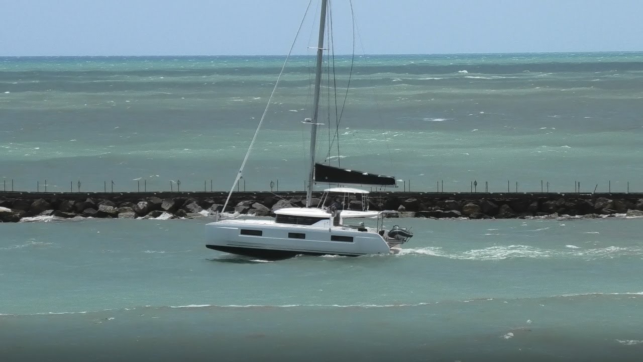 BRAND NEW LAGOON 46 SAILBOAT IN THE STORMY SEAS LEAVING FORT LAUDERDALES PORT EVERGLADES.