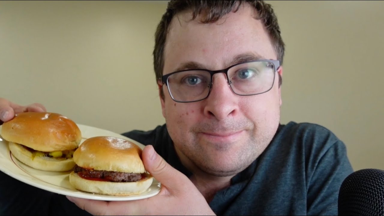 ASMR reading about Dubai, eating cheeseburgers and fries, whispering.