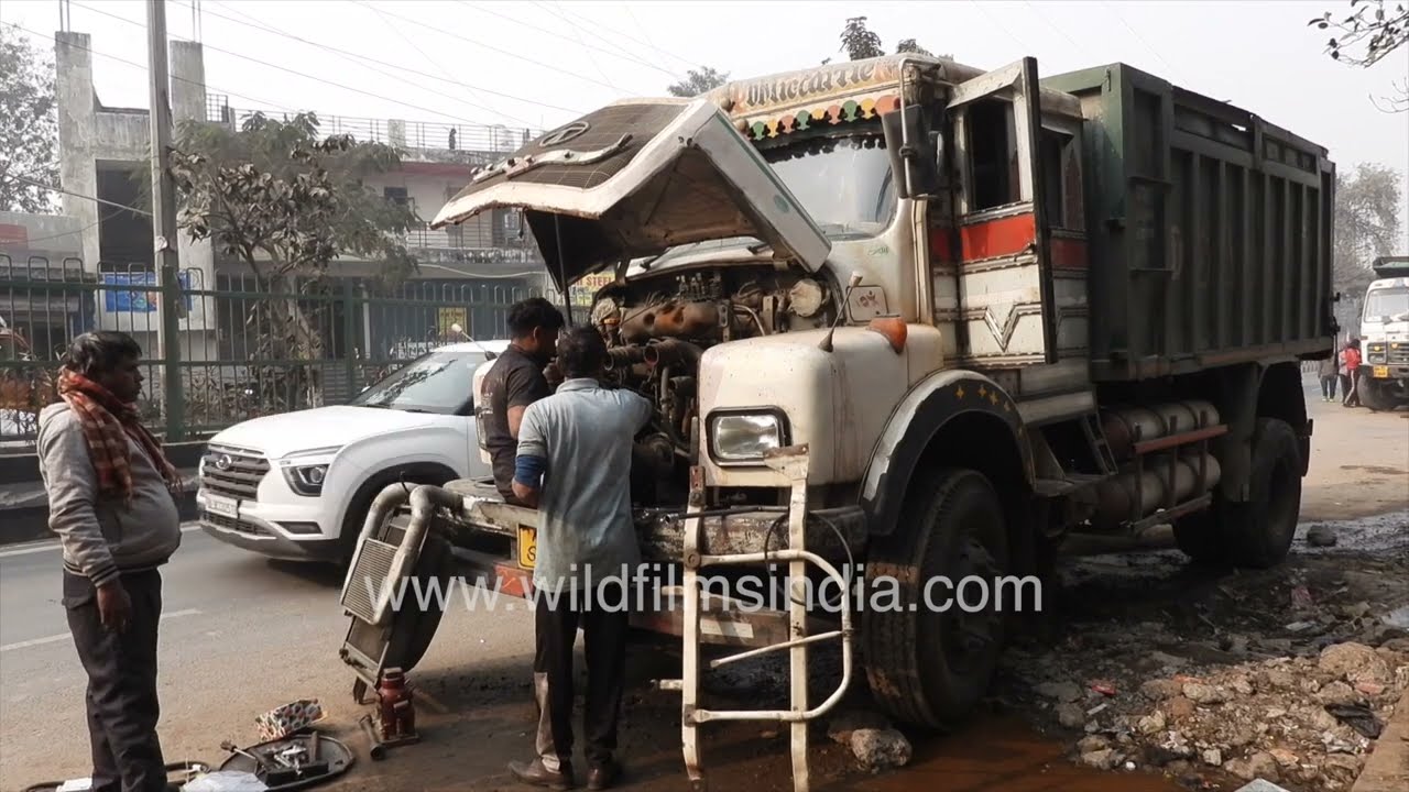 Tata Truck being repaired on an Indian road: Most things happen on roads in India!