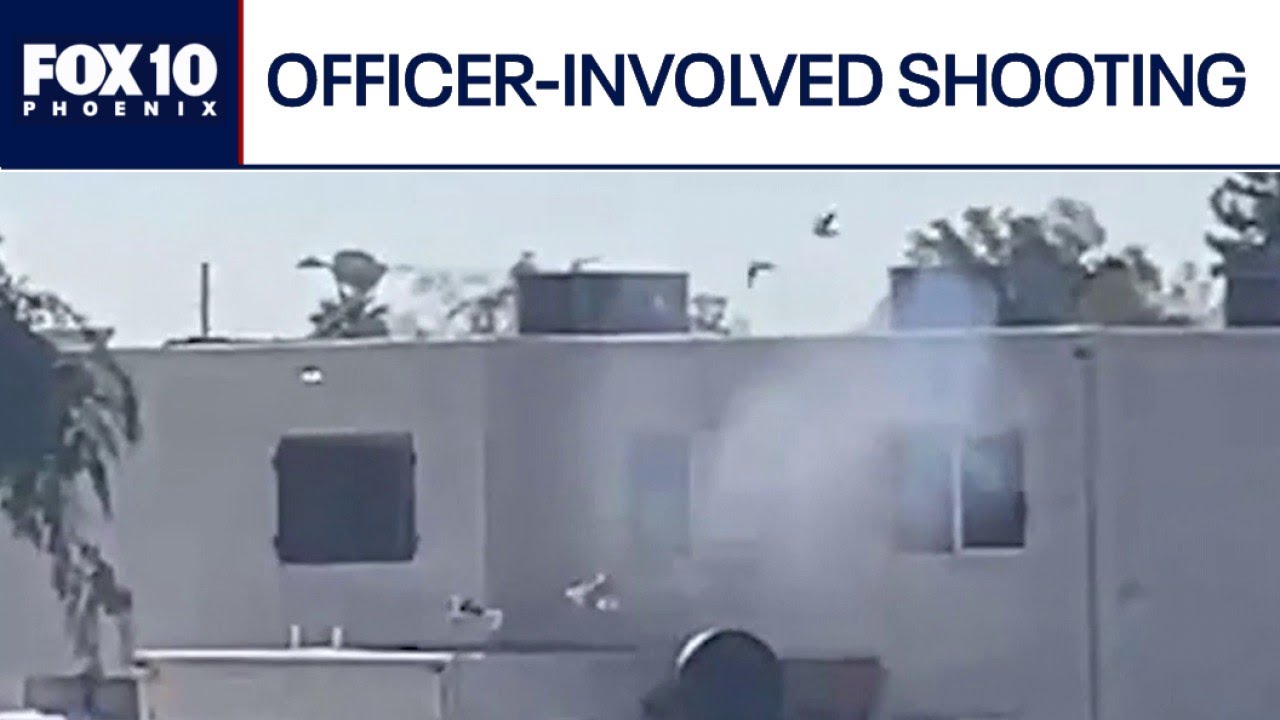 Вооруженный мужчина удерживает мать и ребенка в заложниках перед началом перестрелки с участием п...