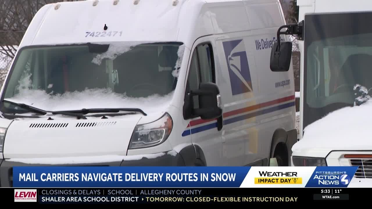 Mail carriers navigate delivery routes in the snow