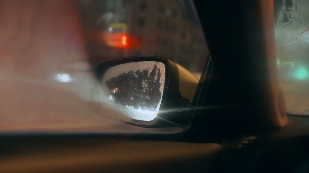 City Traffic at Night through Car's Side View Mirror Stock Footage | Royalty Free