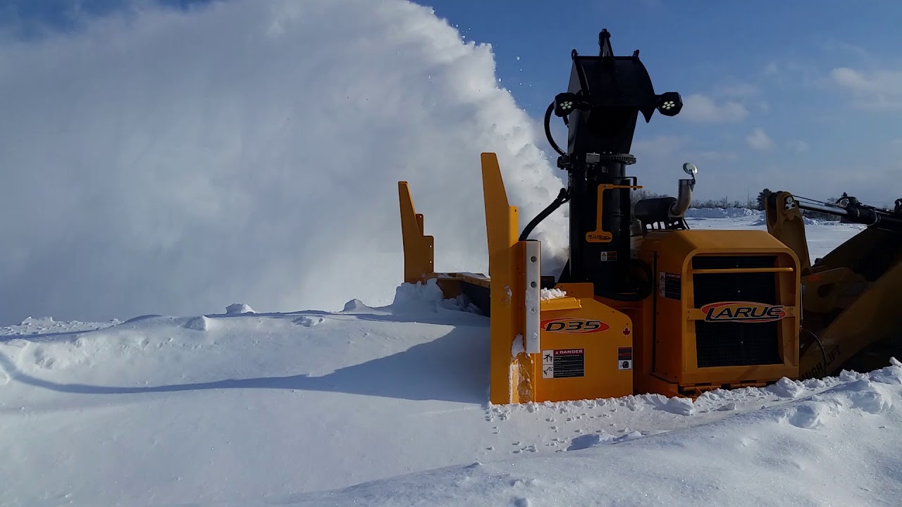Larue D35 loader-mounted snow blower full bucket load
