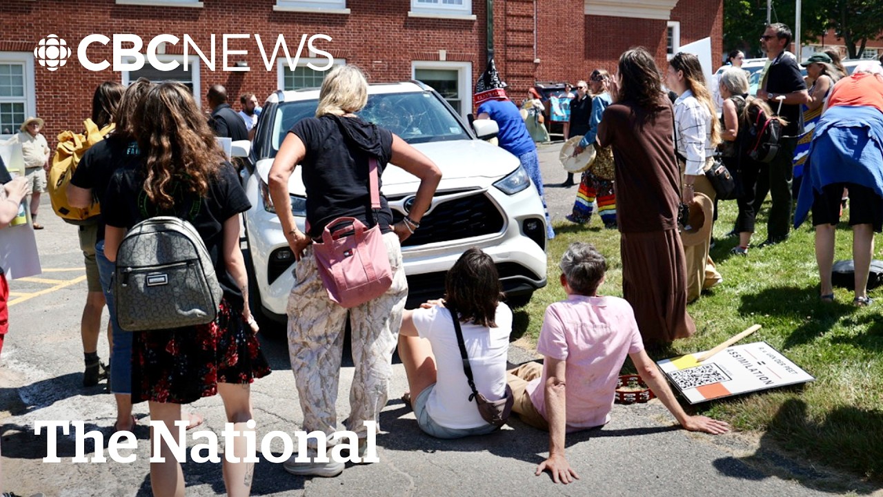 Angry protesters surround N.S. premier Houston's car, smash windshield
