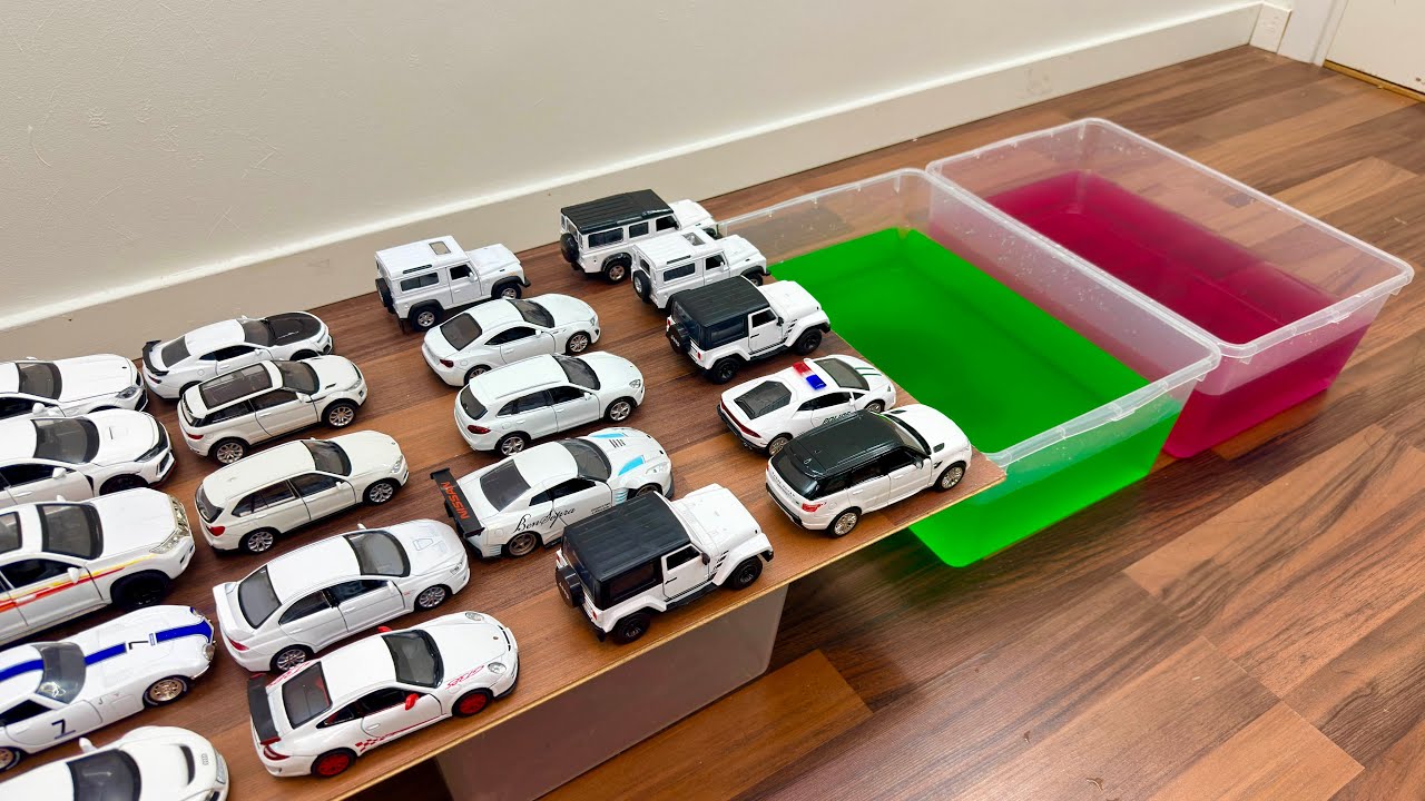 Various White Toy Cars Falling Into The Foamy Water