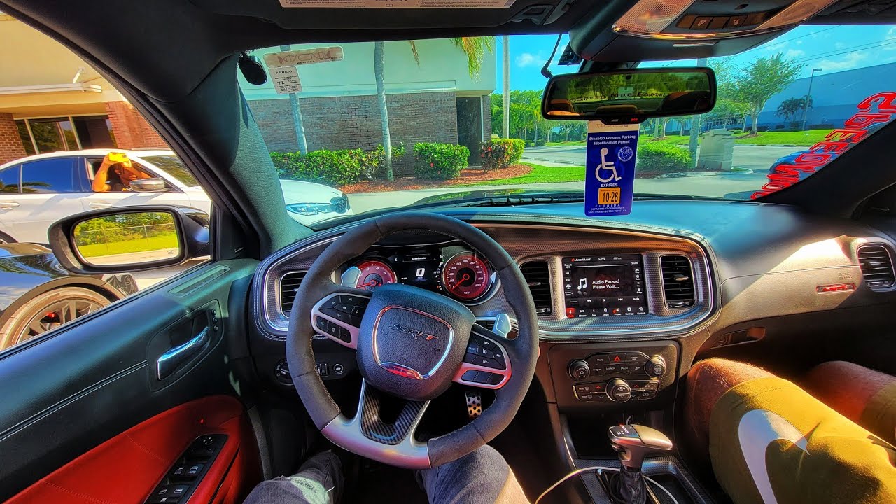 POV drive and drift in a Dodge SRT Hellcat Charger widebody while racing with sports car.