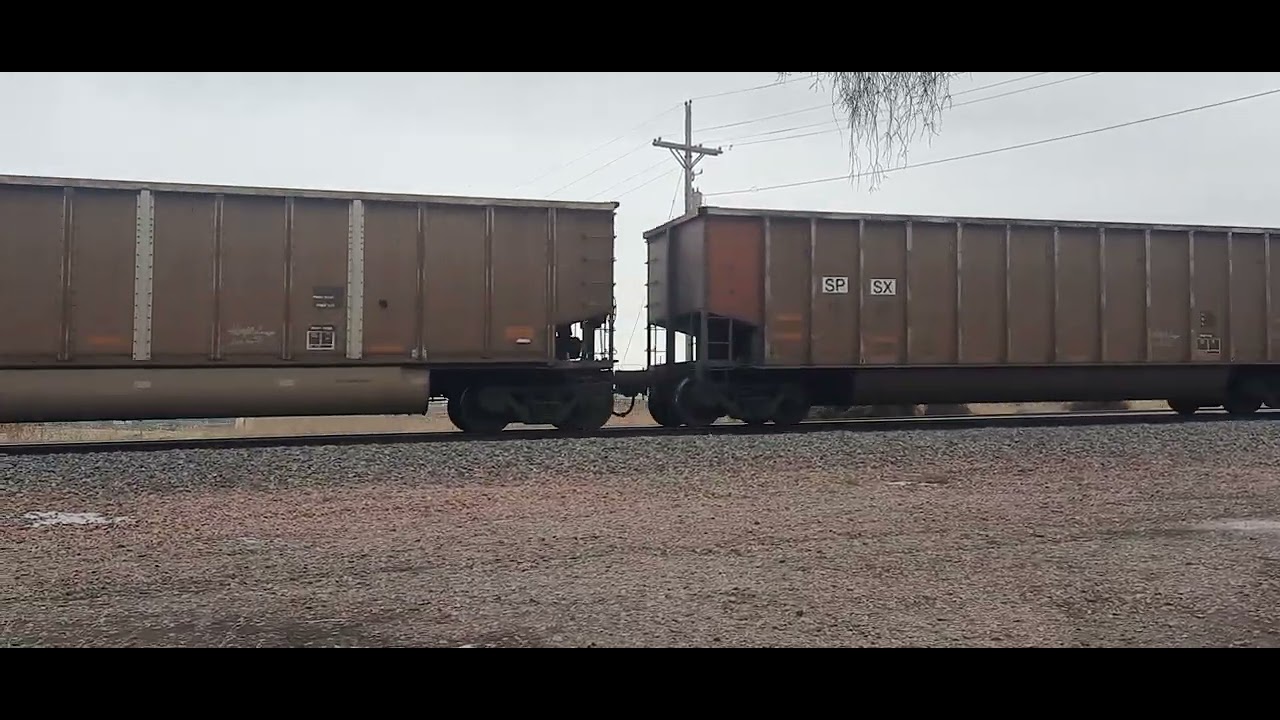 BNSF 9068 leading empty coal train west leaving Grand Island 