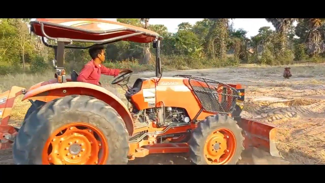 Tractor Kubota M6240SUH Push Soil, Tractor Kubota Ploughing Rice Field In Modern Khmer Agriculture