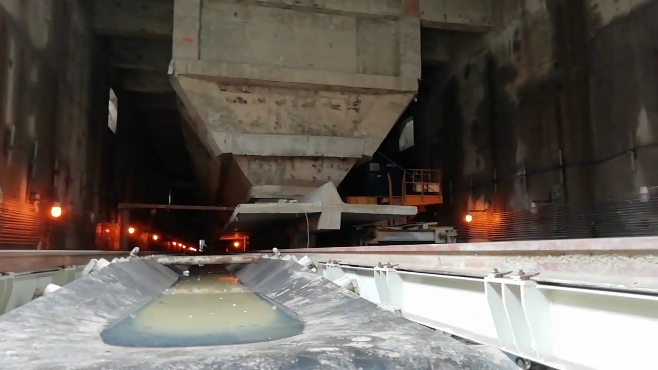 How to tension a conveyor belt using gravity take up
