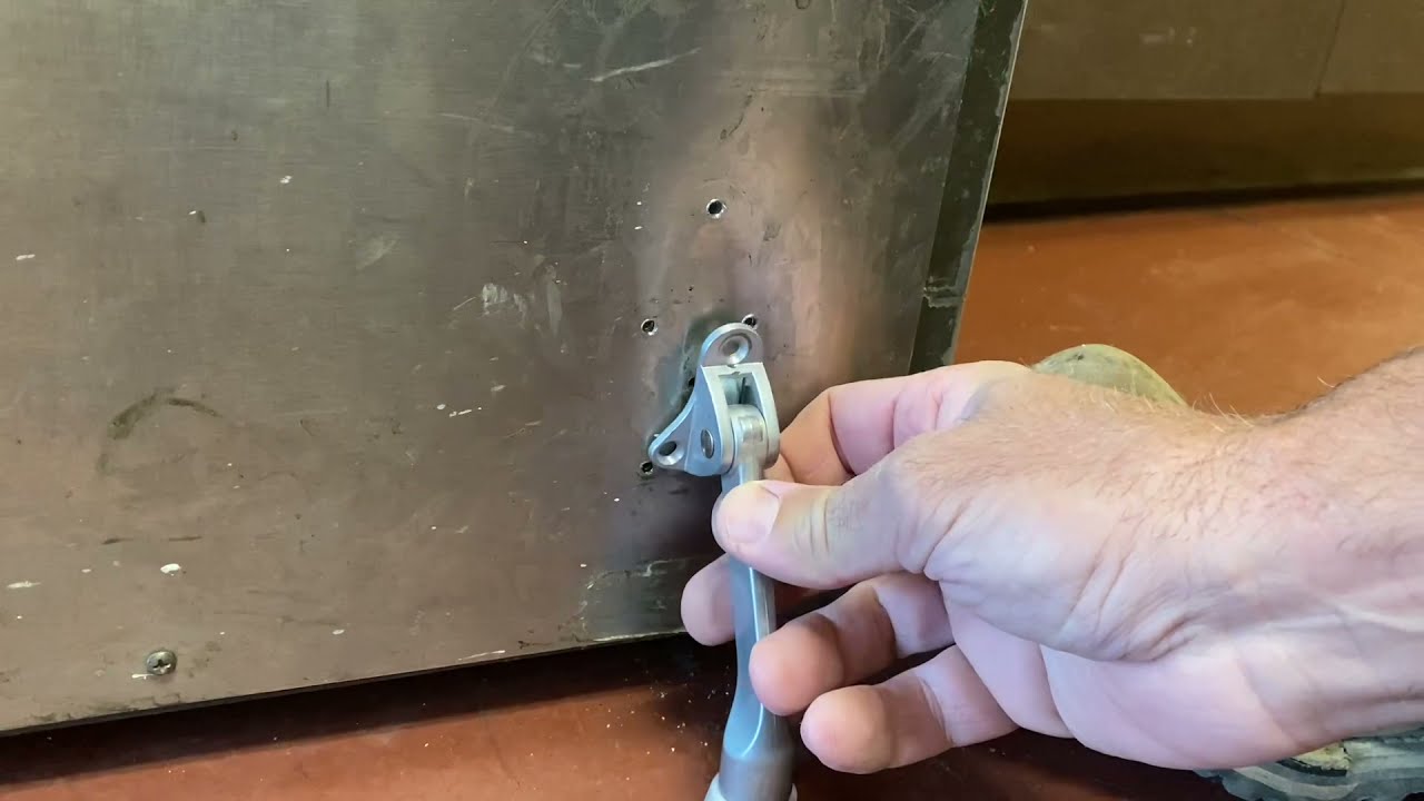 How to install a kick-down door stop on a metal door.