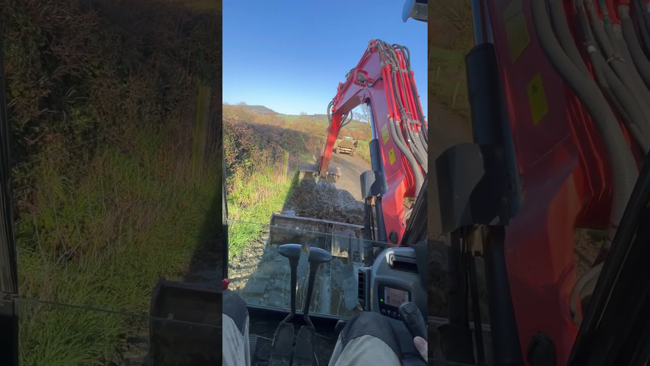 Taking away muck from roadway with Kubota kx080-4