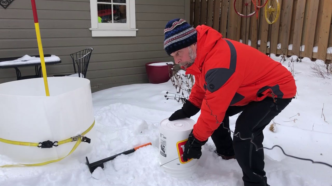 How to fill a pail with snow in preparation for snow sculpting.