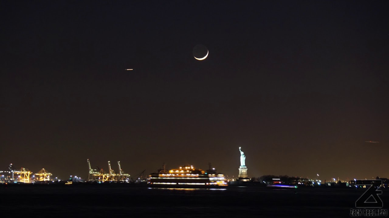 A Time-stack time-lapse of the crescent moon setting over the Statue of Liberty National Monument​