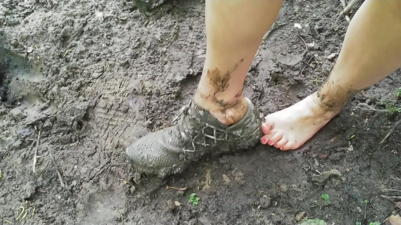 She is trashing in deep mud his Reebok and her Nikes