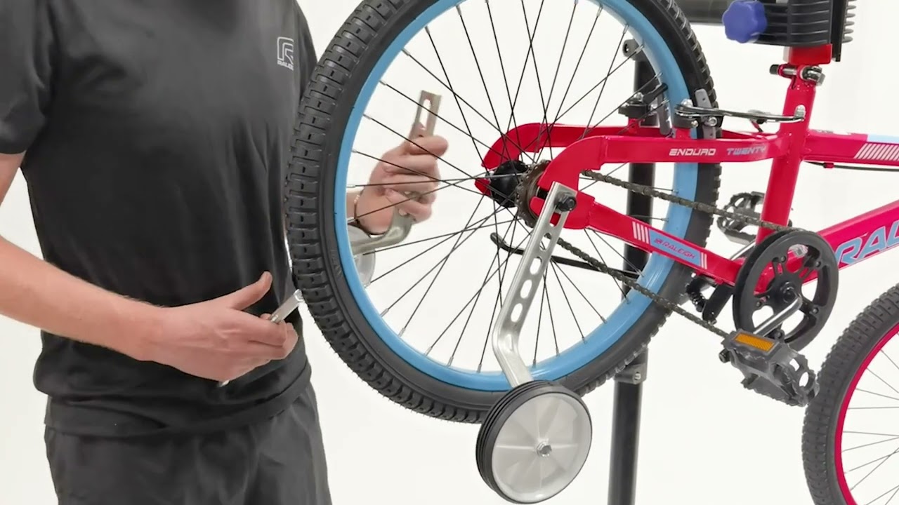 Installing the  training wheels on a  Raleigh bicycle