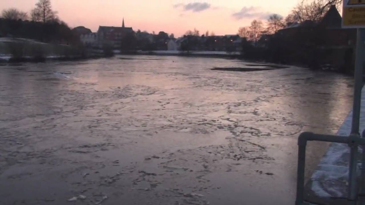 The River Exe frozen in Exeter - Swans in the ice