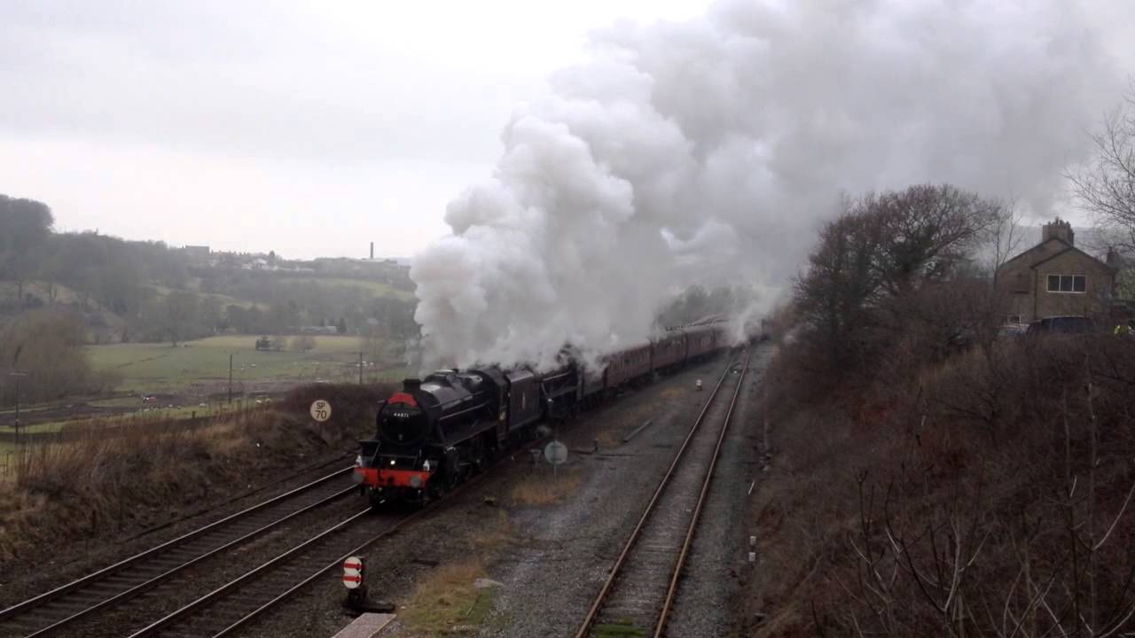 Two Black 5 Steam Locomotives Going Past In New Mills