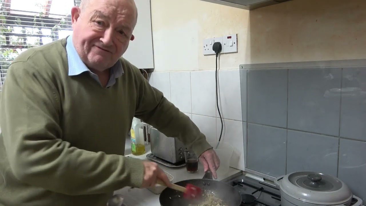 Old man in the kitchen - makes chicken and mushroom risotto