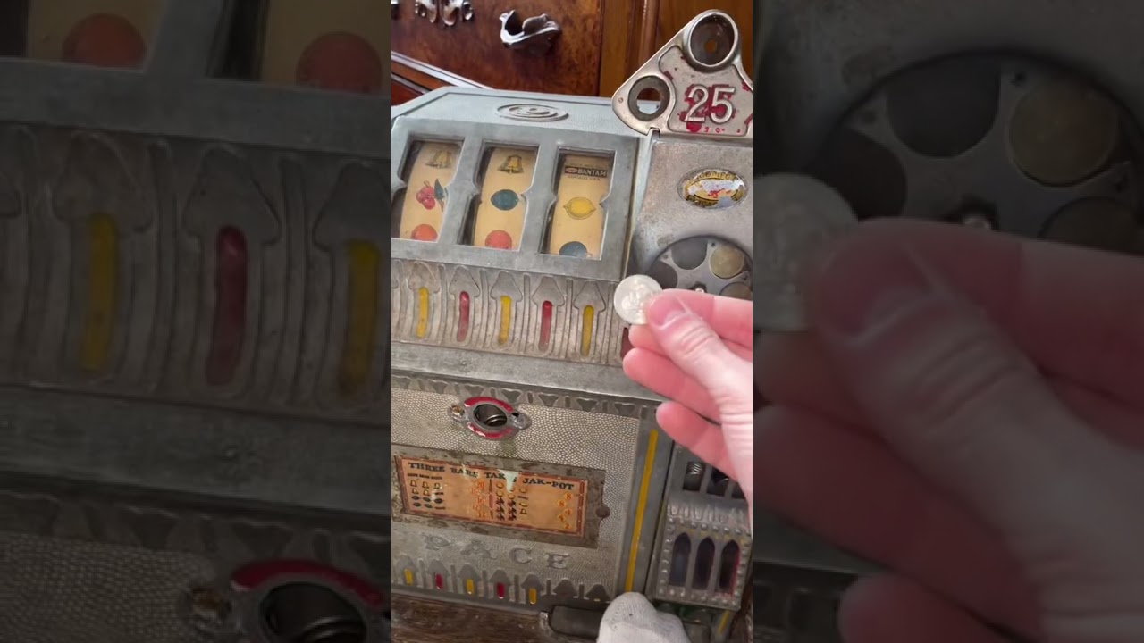 Guy is playing a antique slot machine from the 1930s until he wins the jackpot!