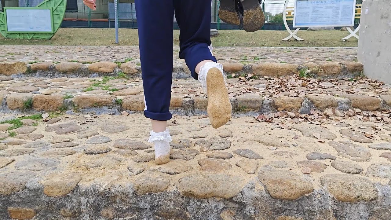 Guli walked along the lake wearing only socks, the socks became very wet and covered with sand