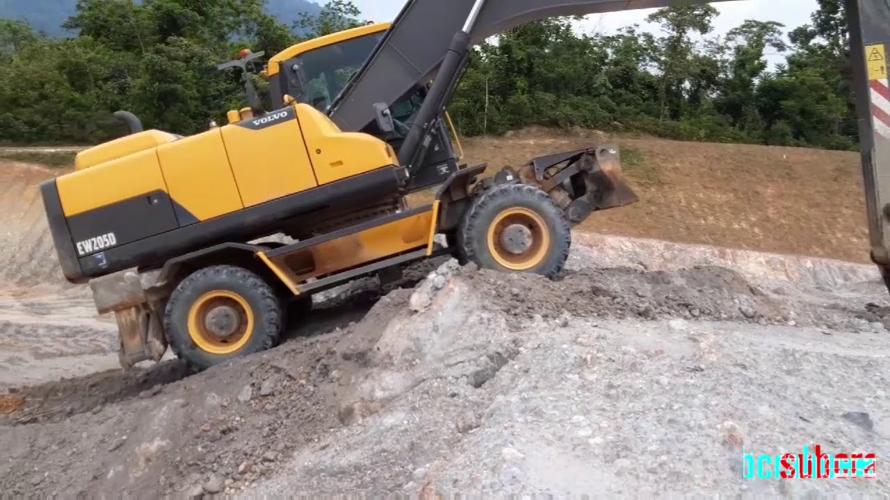 VOLVO EW205D excavator driving technique type rubber tires up slope