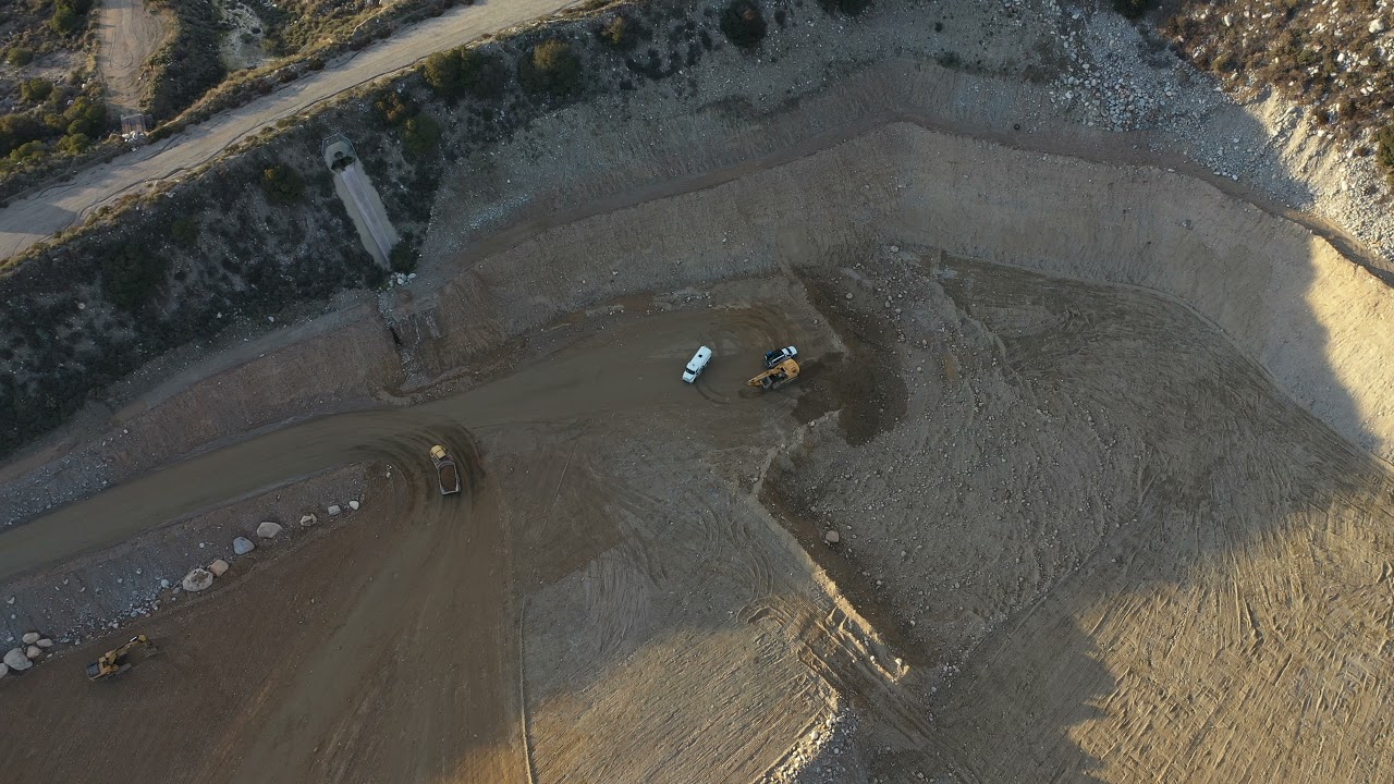 Dump truck traversing rough terrain to transport materials #postmymachine