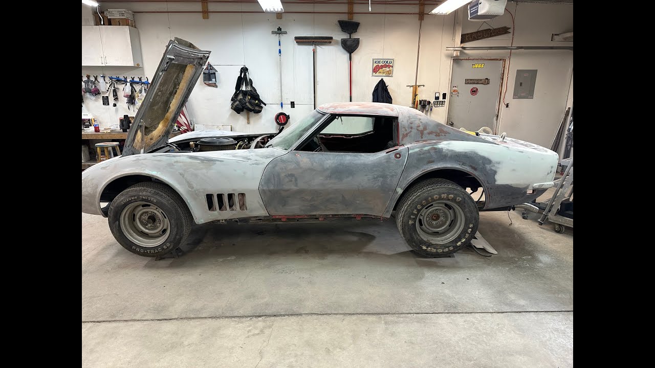 1968 Corvette EP25 primer is on the Vette, pulling the tape and paper looking for obvious flaws