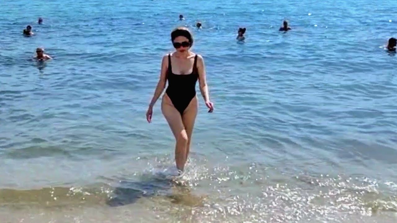 Granate Styling, walking in public, bathing Cannes beach, Cote d`Azur, France, denim shorts