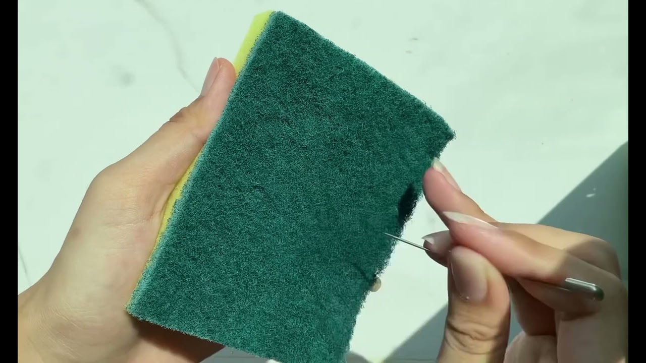 Dry kitchen sponge ripping and squeezing.