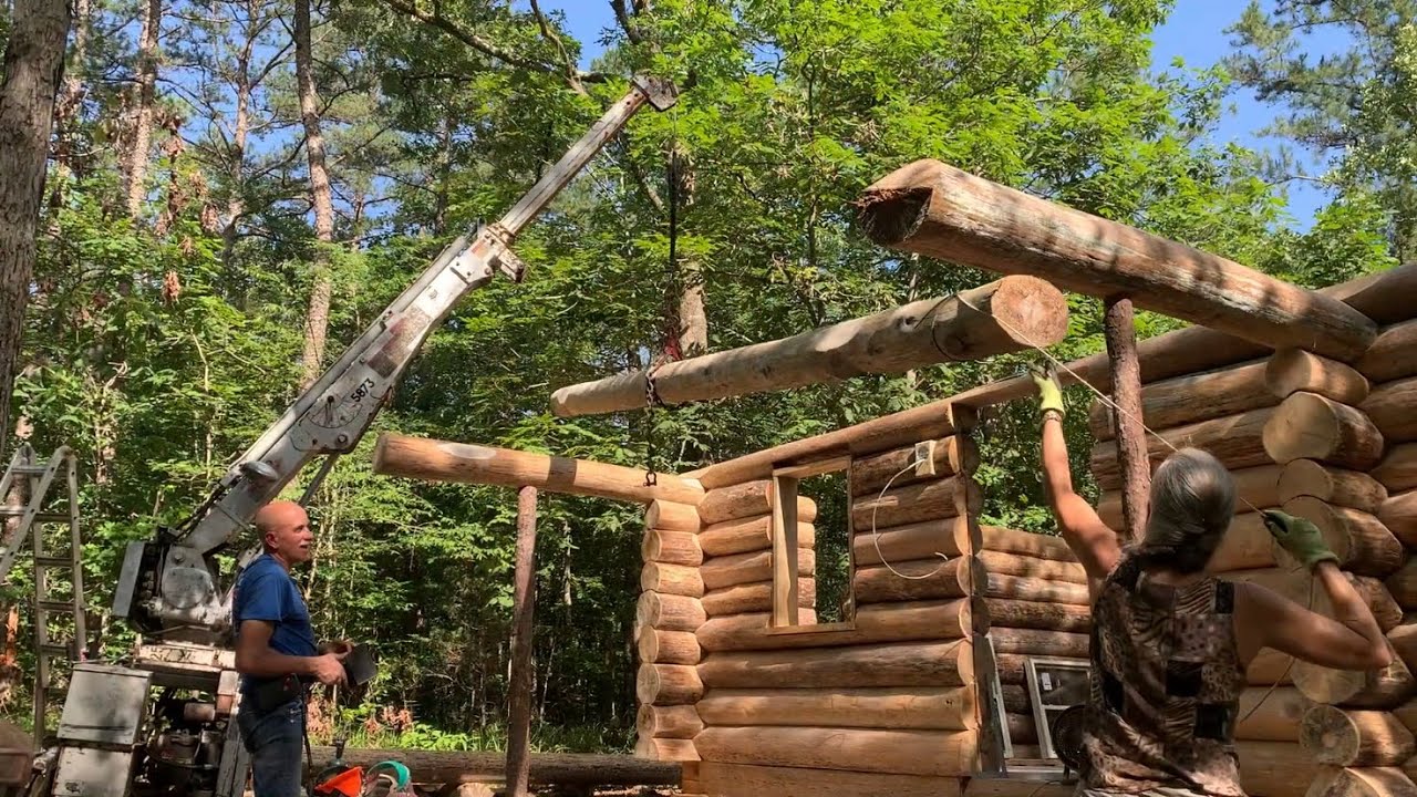 Log cabin build Part 17. Blocking for lights, cutting tops of door and windows, porch beam