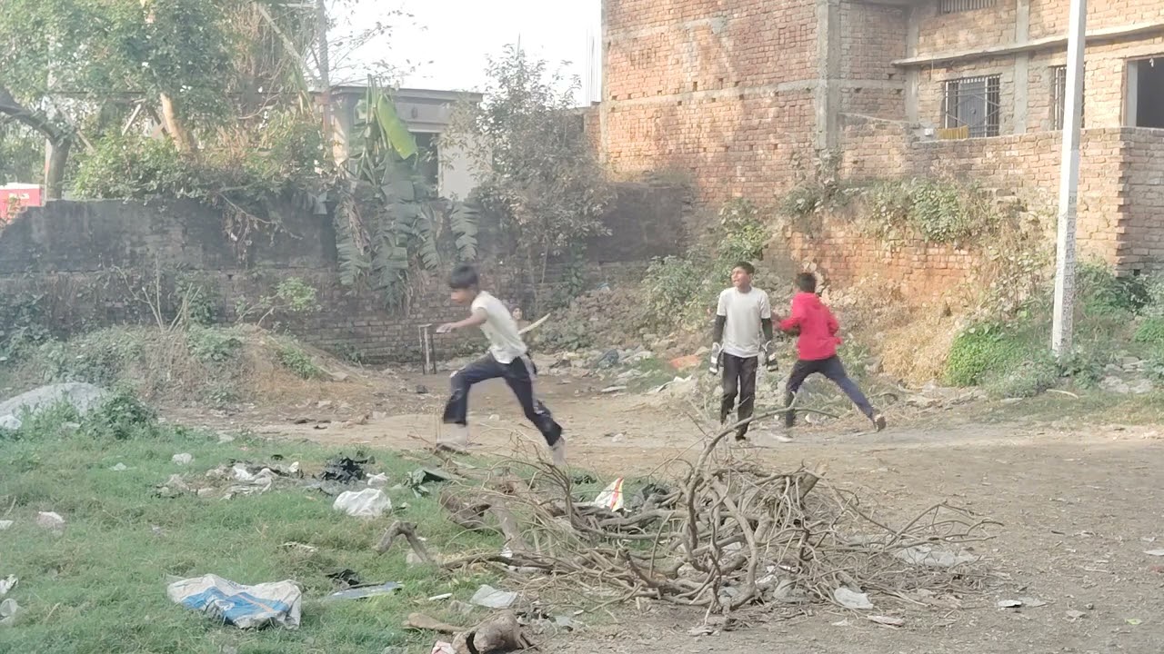 Playing cricket team aside the Reliance tower