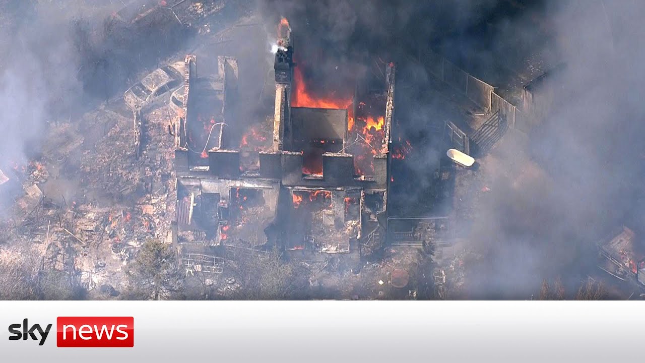 Houses ablaze as grass fire engulfs village outside London