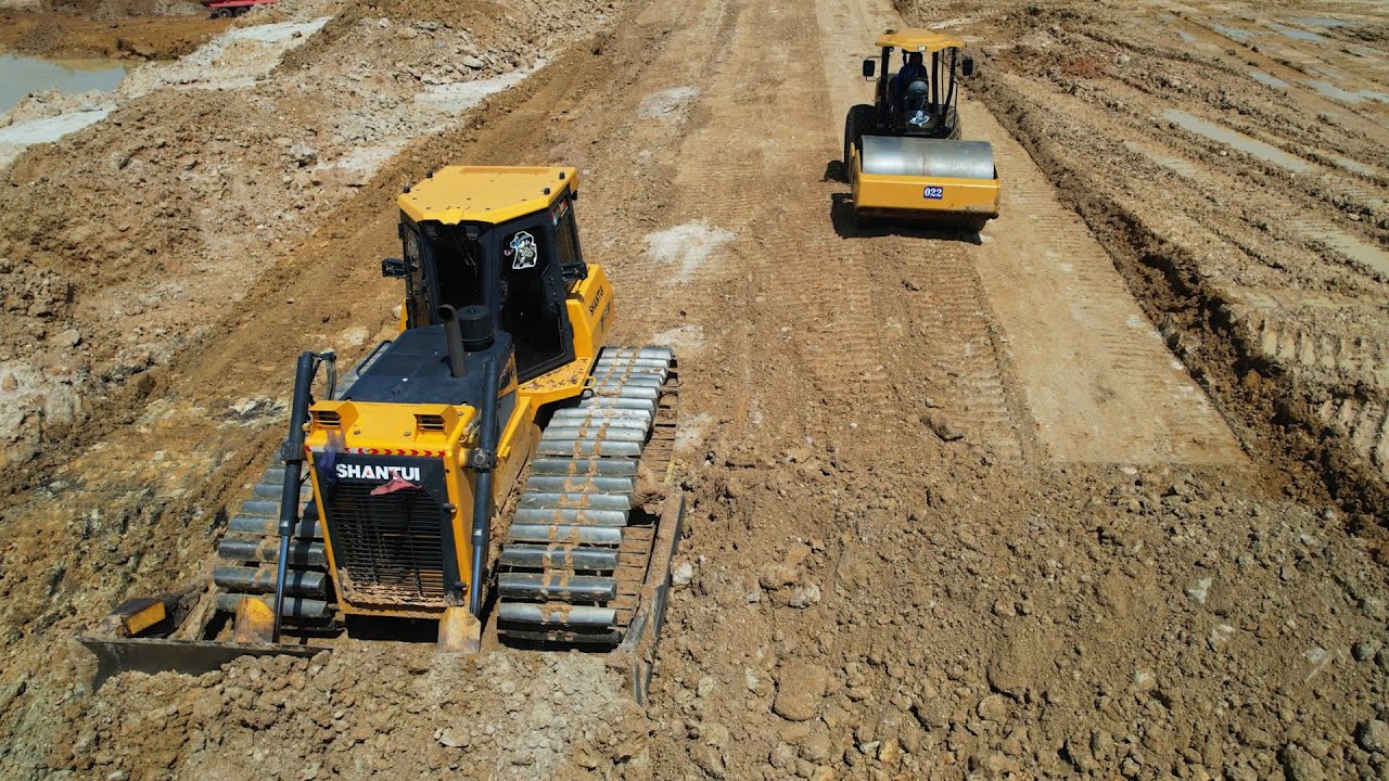 Villager very happy when see construction equipment roller excavator bulldozer working building road