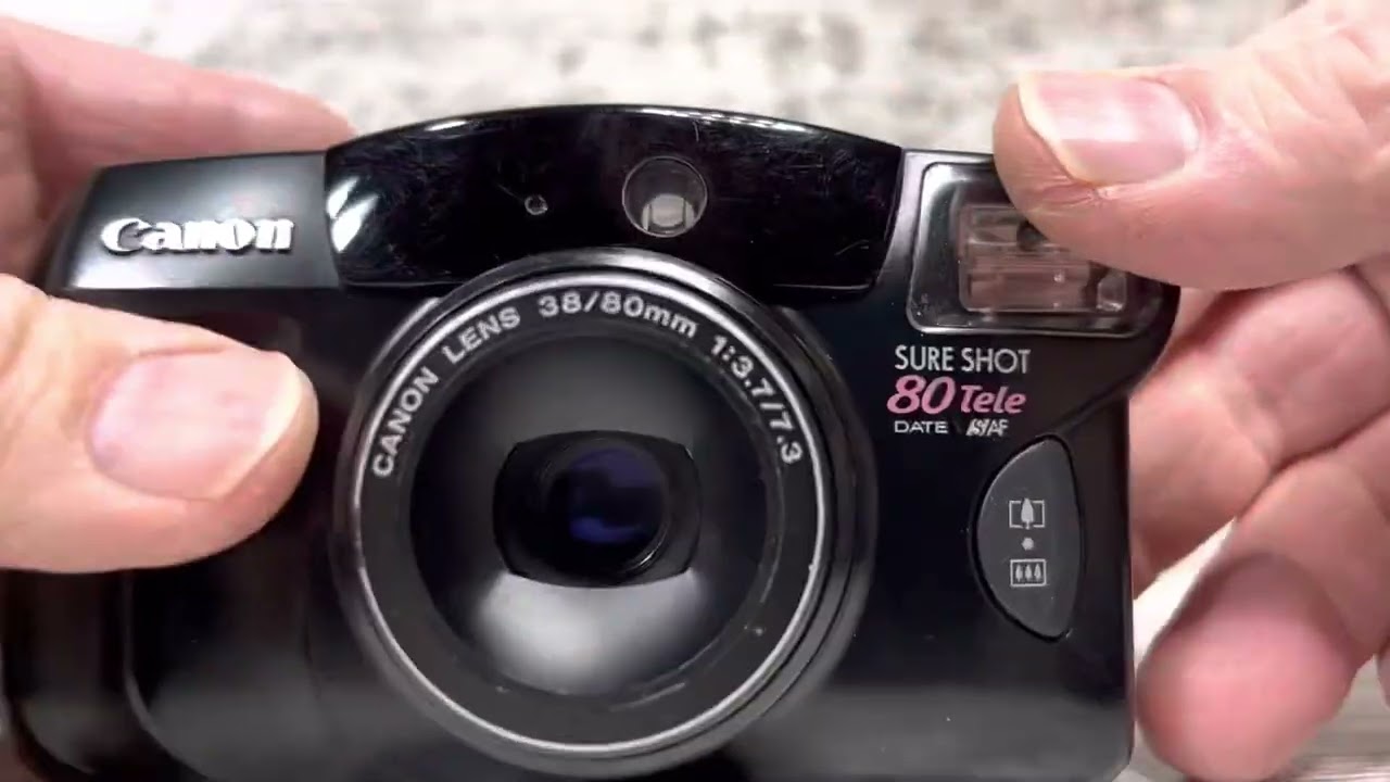 Demonstrating a Canon Sure Shot 80Tele Date SAF 35mm Camera