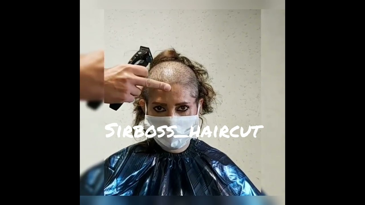 woman headshave in office by barber