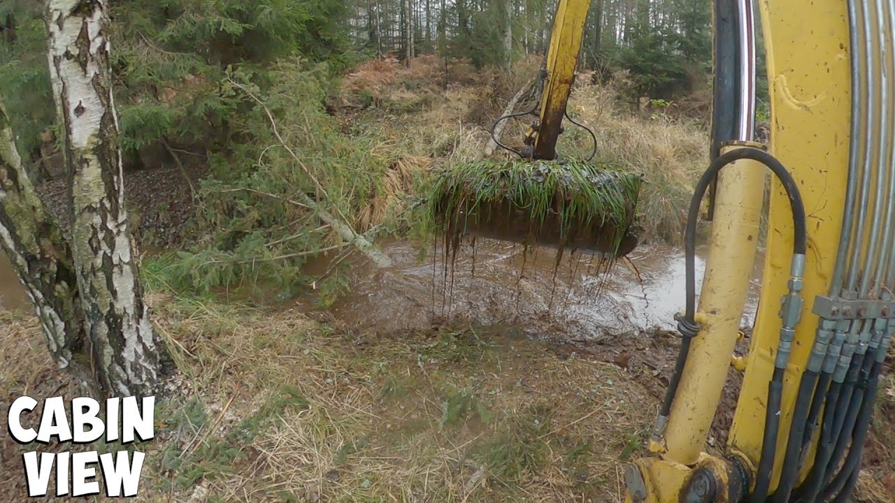 Desilting Drainage Ditch With An Excavator In The Forest