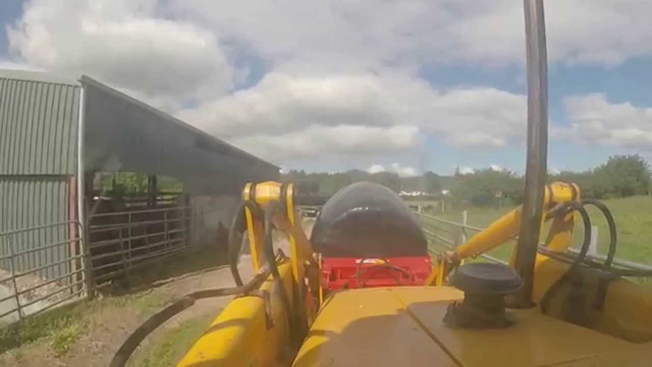 JCB 3CX and John Deere 6330 at silage bales 2014