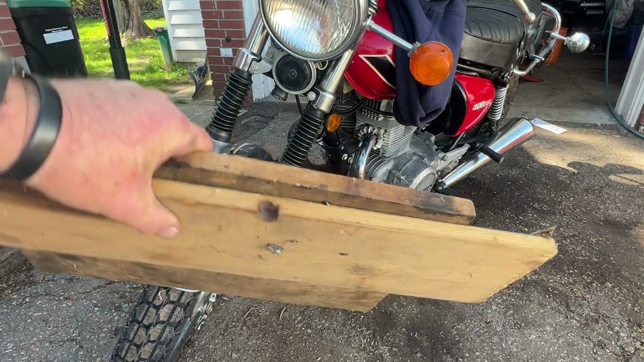 How to safely raise the front wheel on a motorcycle with no centre stand .
